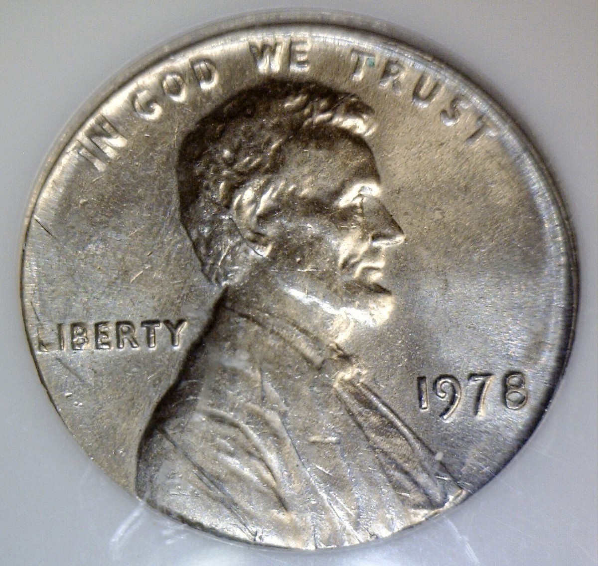 1978 penny struck on Roosevelt dime planchet showing smaller diameter and copper-nickel composition